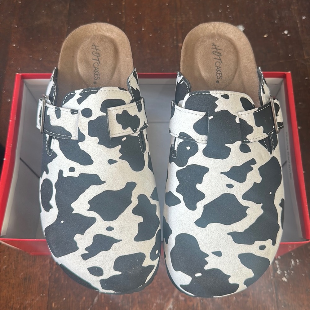 Cow print slip on clogs
